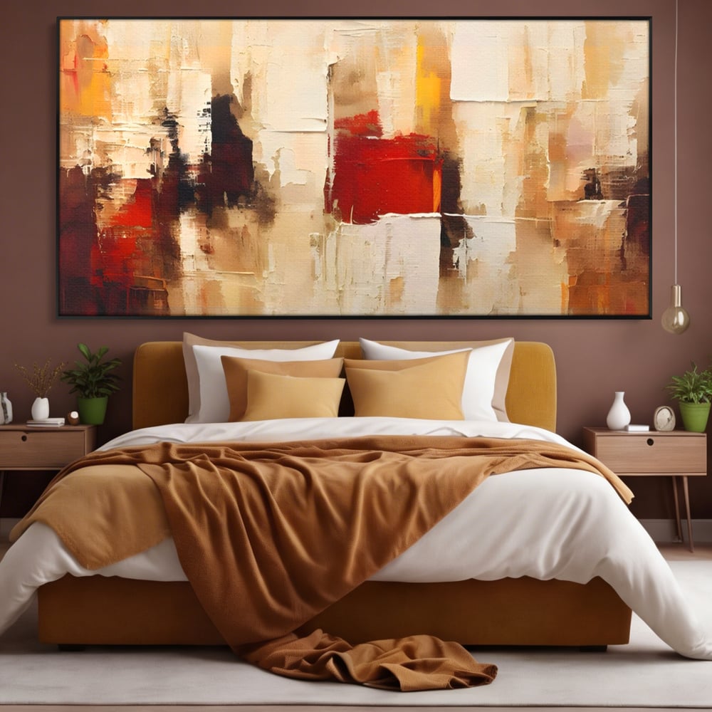 Tablou canvas cu pictura abstracta cu pete de rosu si bej, in rama de aluminiu negru, pe perete intr-un dormitor